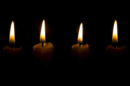 View of lighted candles on black の写真素材