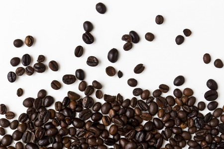 Close up of mixed coffee beans on a white background