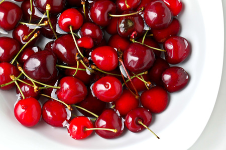 Group of red cherries on white background