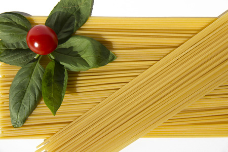Uncooked pasta with basil and tomato of Pachino, Sicilyの写真素材