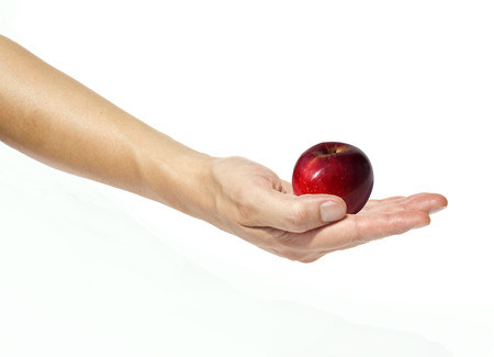 Red apple in a man's hand on a white の写真素材
