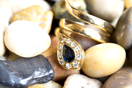 Yellow gold ring with sapphire and diamonds in the shape of snakeの写真素材