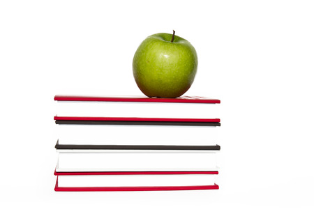 Back to school. Books and apple isolated on white backgroundの写真素材