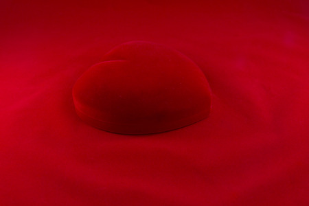 Heart's shape red velvet box in the  isolated on red backgroundの写真素材