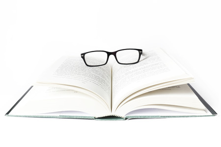 Reading glasses with books isolated on the white background