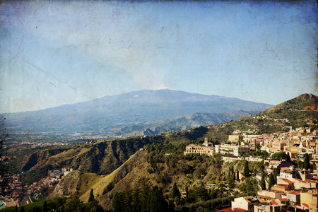 Traditional Sicilian village Taormina with view on Etna volcanoの写真素材