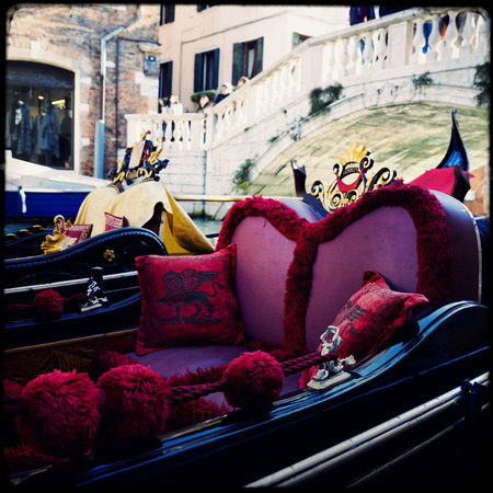 Gondolier on a gondola on the Grand Canal in Venice. Gondola's are a major mode of touristic transport in Venice, Italy.の写真素材