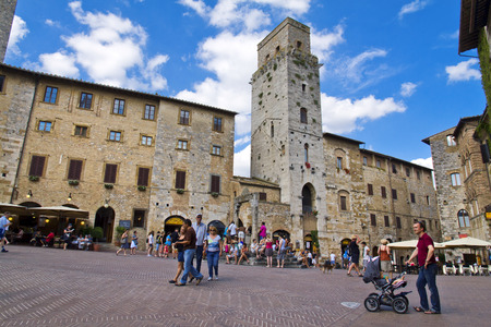 SAN GIMIGNANO, ITALY, August 7, 2011: Tourists walk in San Gimignano, Italy. The Historic Centre of San Gimignano is a UNESCO World Heritage Site.のeditorial素材