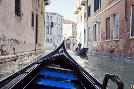 On gondola on the Grand Canal in Venice. Gondola's are a major mode of touristic transport in Venice, Italy.のeditorial素材