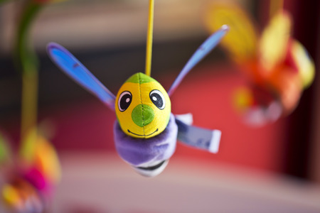Little bee hanging above baby bed. Joust. Toys for babiesの写真素材