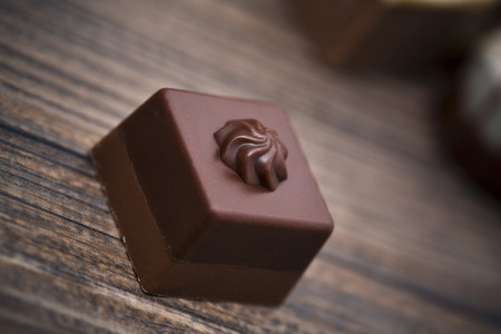 Assorted chocolate pralines on a wooden background