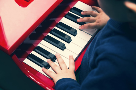 Close up of a child who plays the pianoの写真素材