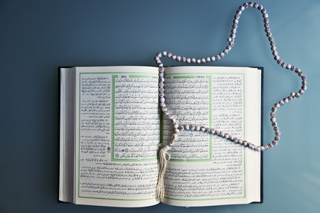 Holy Islamic old book Quran opened and isolatedの写真素材