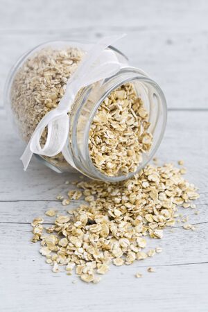 Cereals on wooden background and in a glass jar