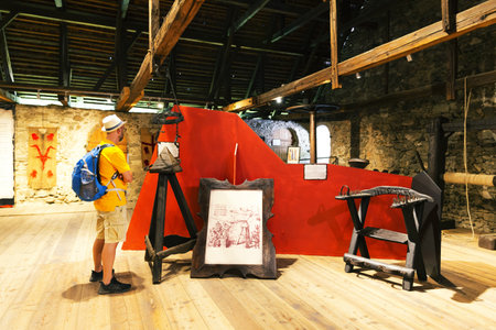 Burg Taufers, July 23, 2019: tourist visits the torture chamber in the castle of Taufers in Val Pusteria, South Tirol, Italyのeditorial素材
