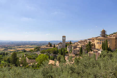 View of the landscape from Piazza Santa Chiara in Assisi, with the church of Saint Mary Maggiore in...
