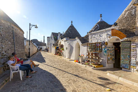 ALBEROBELLO, ITALY: 2021 August 7: Tourists visit the town of Alberobello, famous for its trulliのeditorial素材