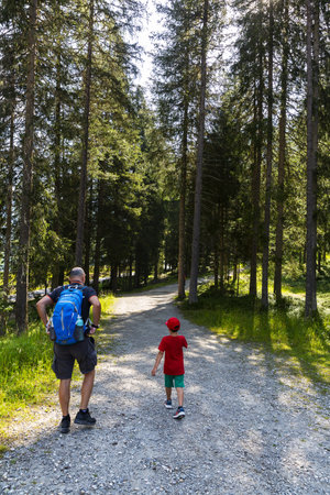 VAL PUSTERIA, ITALY, 2021 August 13: Traveling father and son head to Lake Anterselvaのeditorial素材