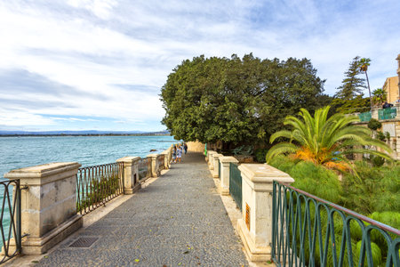 A scenic fountain located along the coast in Ortigia, Syracuseの写真素材