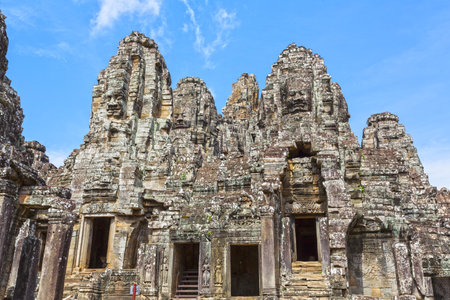 Multiple carved faces adorn the towers of Bayon Temple in Angkor Thomの写真素材