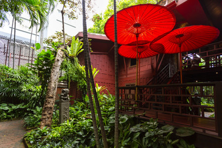 BANGKOK, THAILAND, August 26, 2024: A view of the traditional Thai house and lush tropical garden at the museumの写真素材