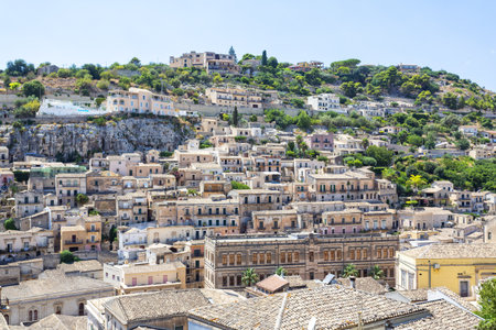 A beautiful view of the Baroque Town of Modica, Sicily, with Terraced Houses and Bell Towersの写真素材