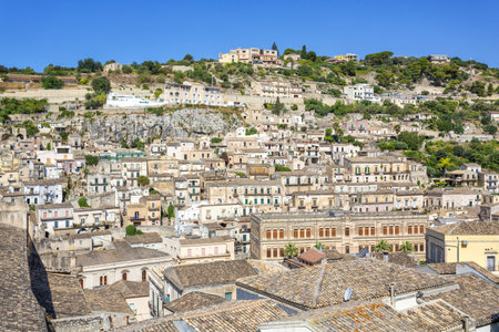 A beautiful view of the Baroque Town of Modica, Sicily, with Terraced Houses and Bell Towersの写真素材