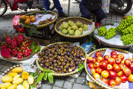 Busy and crowded outdoor street market selling fresh produce and goods in Hanoiの写真素材