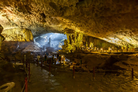 Illuminated interior of a huge limestone cave with stalactites and stalagmites in Ha Long Bay, Vietnamの写真素材