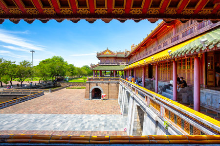 A vibrant photograph capturing a covered gallery and palace building within the Hue Imperial City, Vietnamのeditorial素材