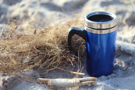 Thermos of coffee on the beachの写真素材