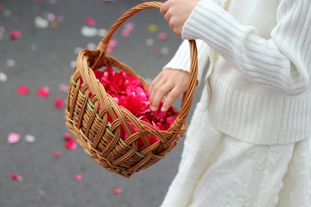 childrens hand throw rose petalsの写真素材