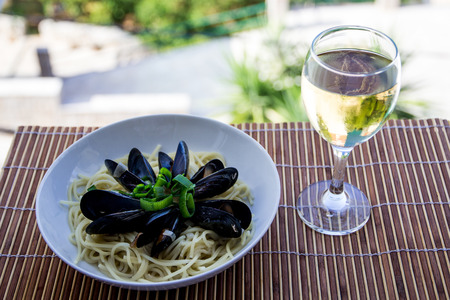 Tasty moule and a glass of white wineの写真素材