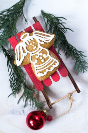 Gingerbread angel on a wooden vintage sleigh