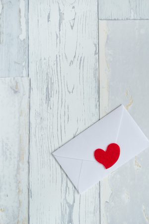 envelope with red heart on a vintage backgroundの写真素材