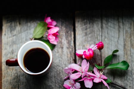 tasty coffee in a cup on a wooden tableの写真素材