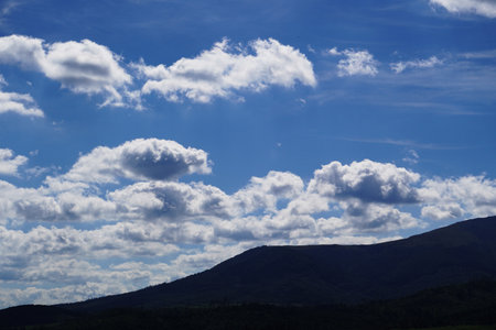 Clouds in the blue sky over a mountain range in New Mexicoの写真素材