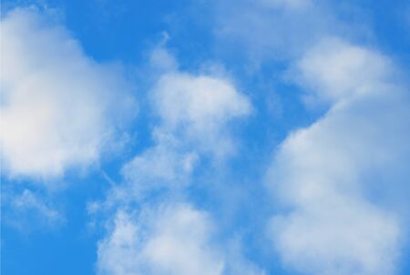 Summer background with white flying clouds on blue sky. Romantic natural heaven backdrop.の写真素材
