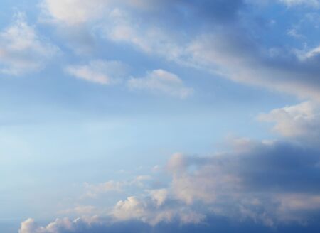 Summer background with white flying clouds on blue sky. Romantic natural heaven backdrop.の写真素材