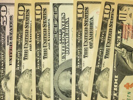 Colorful background with money US dollars of different value. Top view of business concept with finance for banks. American banknotes 5, 10, 50, 100 dollars backdropの写真素材