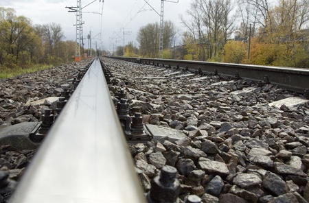 Train track covered with fallen leaves in autumn