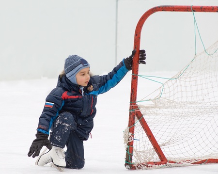 Little kid is goaltender  Playing on a backyard