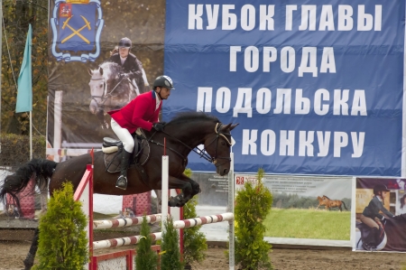 PODOLSK - OCTOBER 6  Eduard Tikot  ride on horse on tournament show jumping of major of city Podolsk on October 6, Podolsk, Russiaのeditorial素材