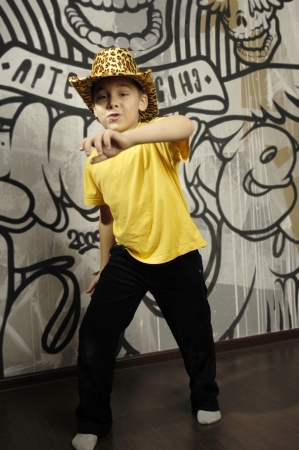 Little kid dancing near the abstract wallの写真素材
