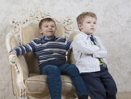 Studio shot of two children sutting in chairの写真素材