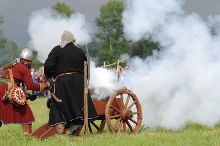 RUSSIA, MOLODI VILLAGE - JULY 27: Unidentified people shooting by cannon on event dedicated to Victory in battle near the Molodi village 1572, on July 27, 2013, in Moscow region, Russiaのeditorial素材