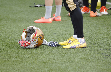 RUSSIA, PODOLSK CITY - JULY 27  Helmet on the grass on friendship football game Spartans vs Vityazi on July 27, 2013, in Moscow region, Podolsk city, Russiaのeditorial素材