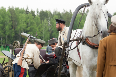 RUSSIA, CHERNOGOLOVKA - MAY 17: Unidentified men load machine gun on cart on History reenactment of...