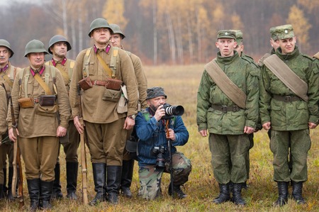 RUSSIA, BORODINO - OCTOBER 12: Unidentified photographer shooting on reenactment of the battle in WWII near the Borodino village in 1941, in Moscow region, Borodino, on 12 October, 2014, Russiaのeditorial素材