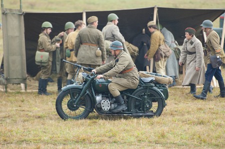 RUSSIA, BORODINO - OCTOBER 12: Unidentified armed soldiers drive on motorbike on reenactment of the...